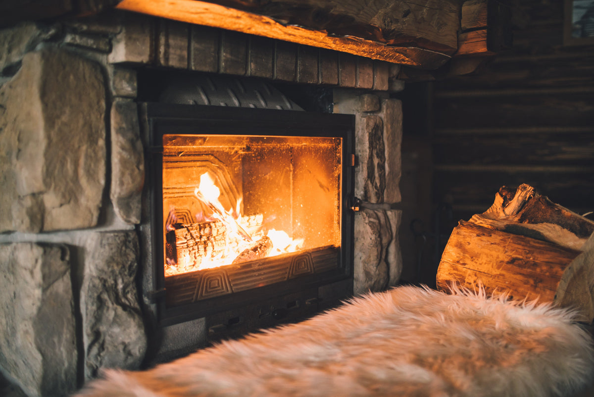 Oak firewood logs by a lit stove